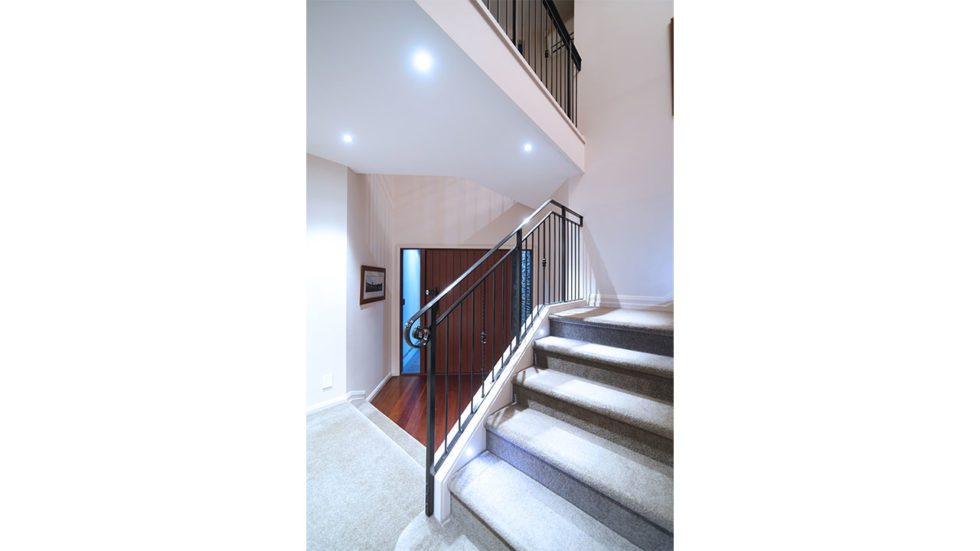 dropdown lights in entryway leading to stairs
