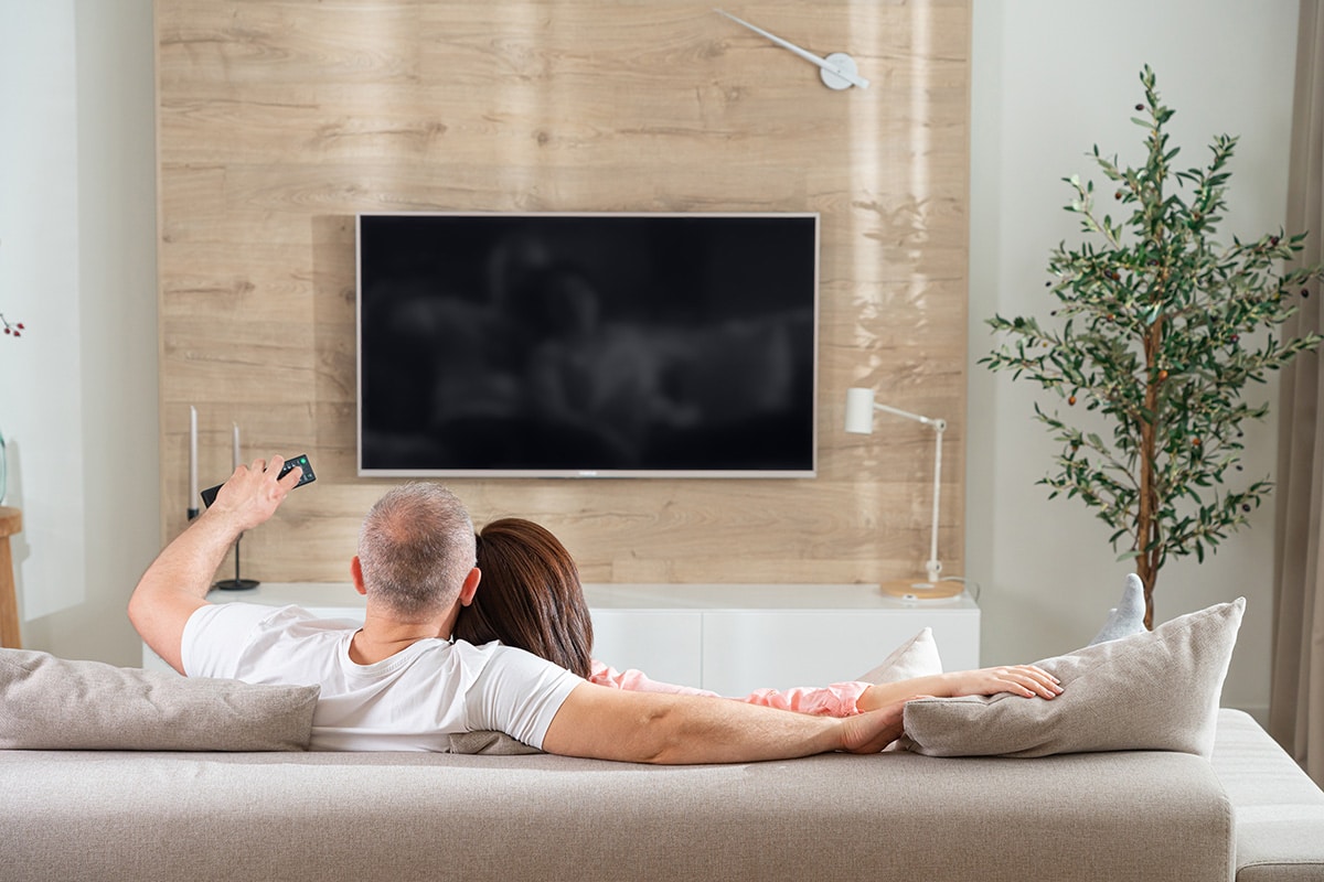 couple watching wireless TV in living room