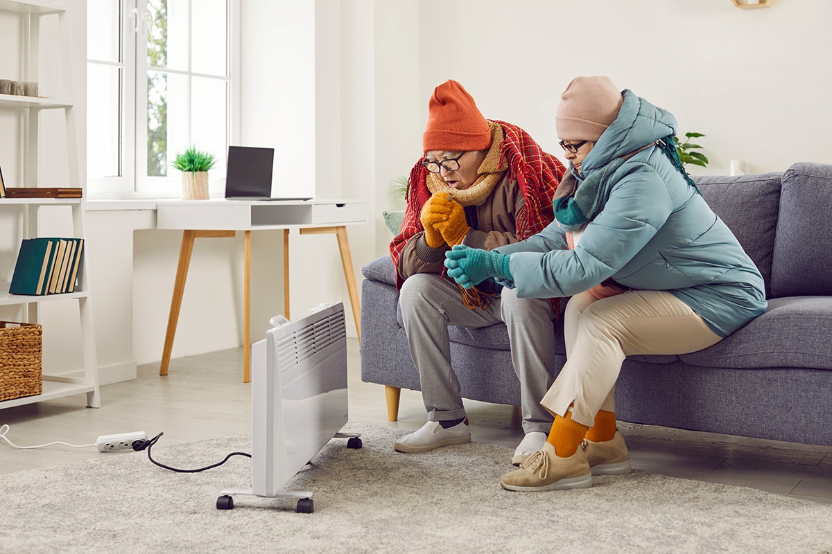 couple huddled near heat pump