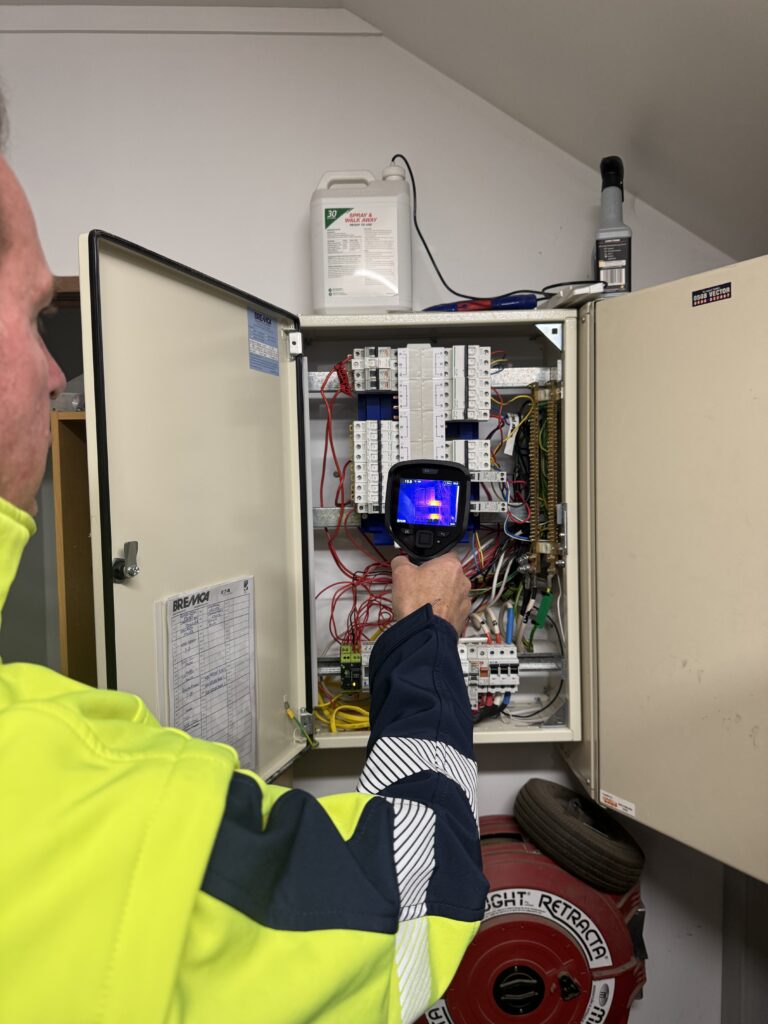French Electrical electrician testing commercial electrical equipment in Auckland