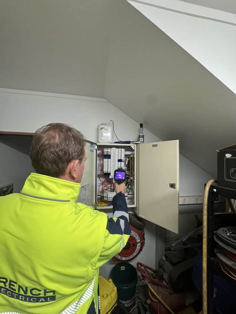 Electrician checking whether a switchboard needs upgrading